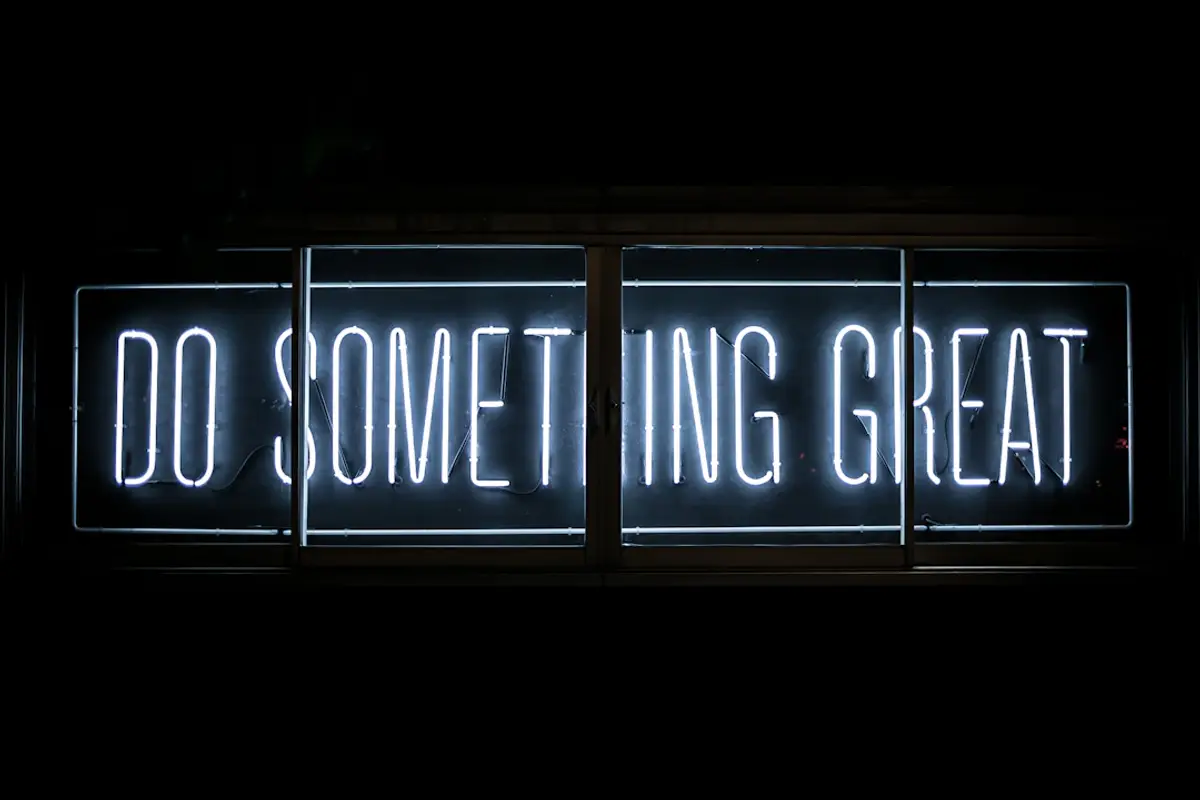 neon sign with the phrase 'do something great' in white letters