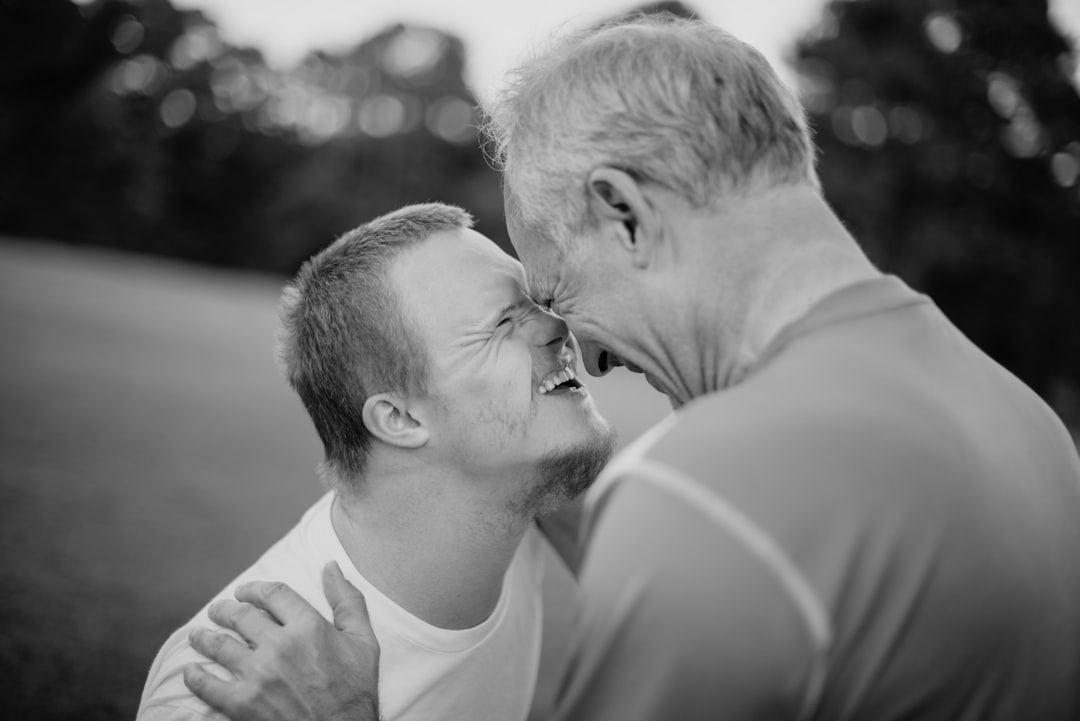 two people smiling and touching foreheads, showing affection and connection